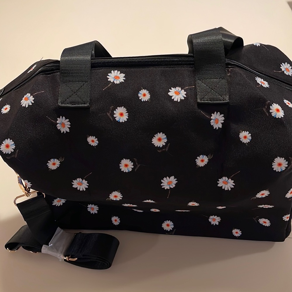 Alice+Olivia black Daisy duffel bag.